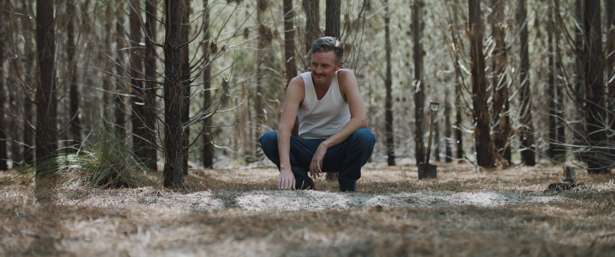 HOL_John squatting in woods